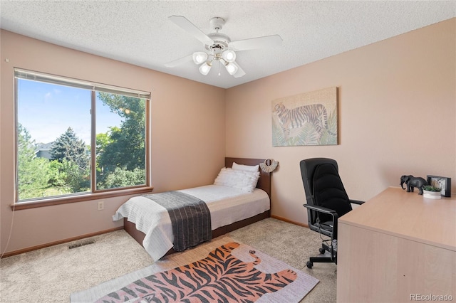 9447 Chesapeake St, Highlands Ranch, CO 80126 - bedroom with light colored carpet, a desk, a ceiling fan, and a textured ceiling
