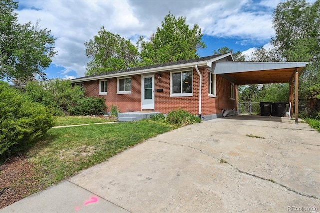 1646 S Stuart St, Denver, CO 80219 - ranch-style home featuring brick siding, concrete driveway, a front lawn, and a carport