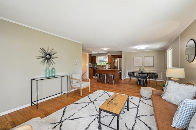 1646 S Stuart St, Denver, CO 80219 - living room featuring light wood-type flooring, crown molding, and baseboards