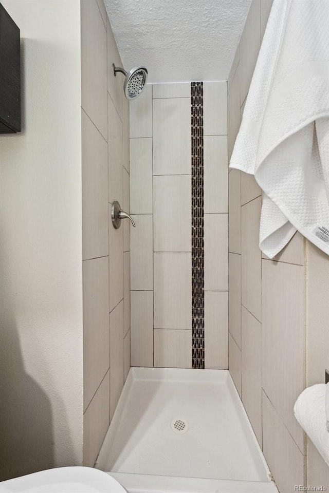 1646 S Stuart St, Denver, CO 80219 - full bathroom with a stall shower and a textured ceiling