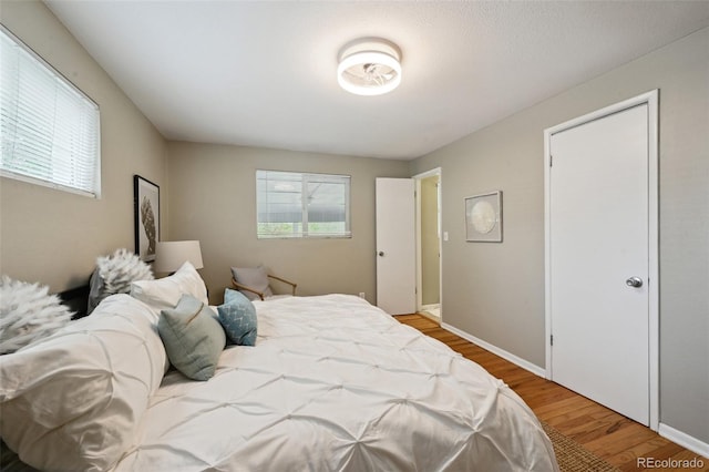 1646 S Stuart St, Denver, CO 80219 - bedroom with light wood-style flooring and baseboards