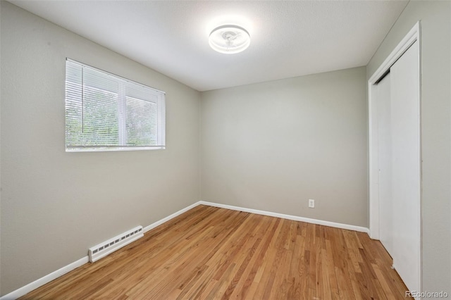 1646 S Stuart St, Denver, CO 80219 - unfurnished bedroom featuring baseboards, light wood finished floors, and a closet