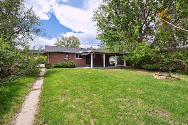 1646 S Stuart St, Denver, CO 80219 - rear view of property with a yard, brick siding, and a fire pit