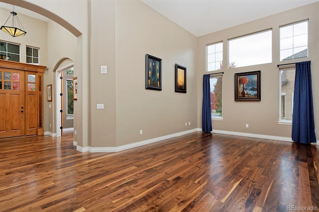 14022 E Fair Pl, Centennial, CO 80111 - entrance foyer with a high ceiling, arched walkways, healthy amount of natural light, and dark wood-style floors