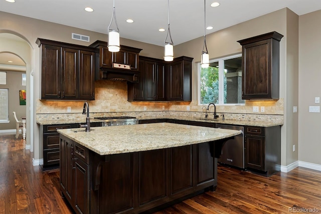 14022 E Fair Pl, Centennial, CO 80111 - kitchen with stainless steel dishwasher, a sink, an island with sink, dark wood-style floors, and recessed lighting