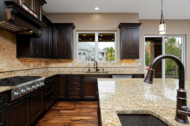14022 E Fair Pl, Centennial, CO 80111 - kitchen with a sink, stainless steel gas cooktop, range hood, dark brown cabinetry, and recessed lighting