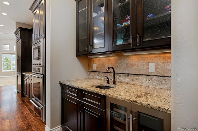 14022 E Fair Pl, Centennial, CO 80111 - indoor wet bar with a warming drawer, stainless steel appliances, wine cooler, dark wood finished floors, and recessed lighting