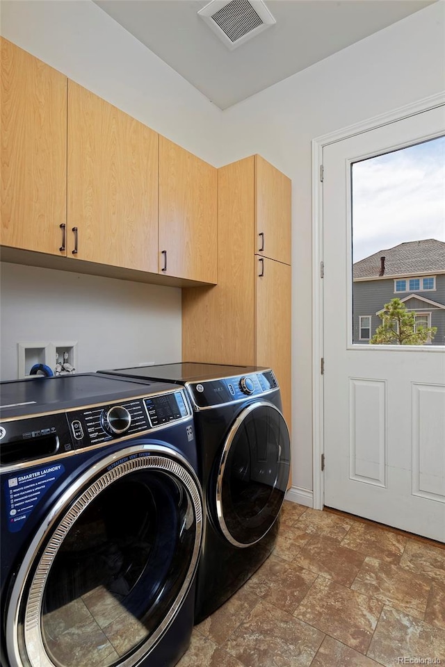 14022 E Fair Pl, Centennial, CO 80111 - laundry area featuring cabinet space, washer and clothes dryer, and stone finish flooring