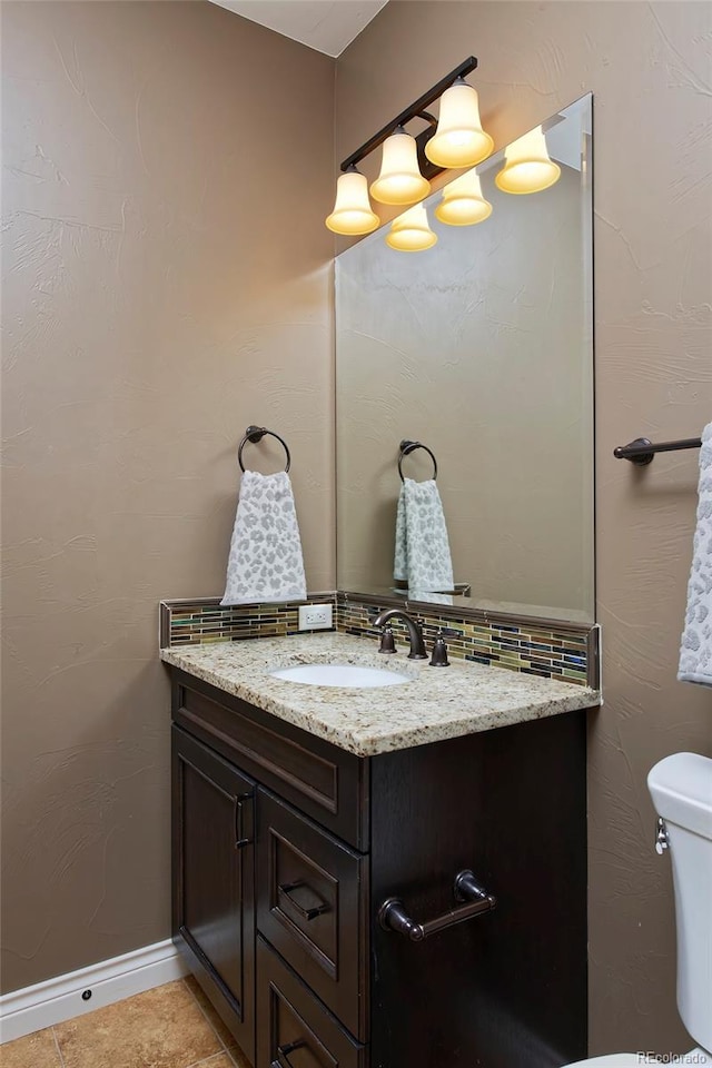 14022 E Fair Pl, Centennial, CO 80111 - half bath featuring vanity, toilet, tile patterned floors, and baseboards