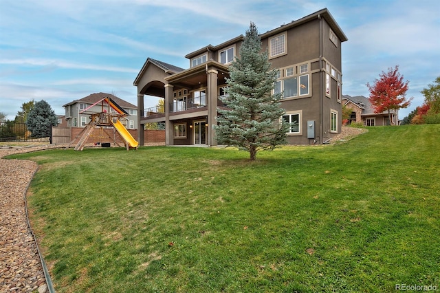 14022 E Fair Pl, Centennial, CO 80111 - rear view of house with a playground, a balcony, and stucco siding