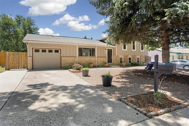 4589 S Sleepy Hollow Cir, Colorado Springs, CO 80917 - tri-level home with brick siding, concrete driveway, a garage, board and batten siding, and roof with shingles