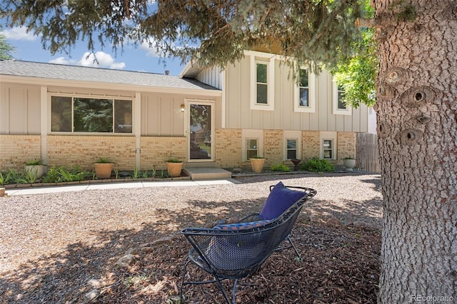 4589 S Sleepy Hollow Cir, Colorado Springs, CO 80917 - tri-level home with brick siding, board and batten siding, and a shingled roof