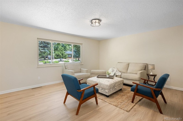 4589 S Sleepy Hollow Cir, Colorado Springs, CO 80917 - living room featuring light wood-style floors and a textured ceiling