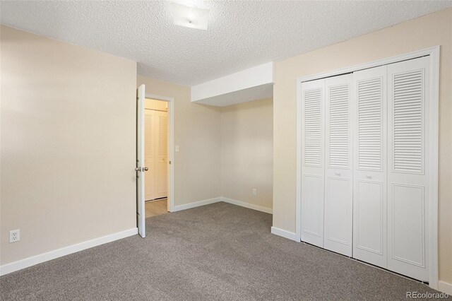 4589 S Sleepy Hollow Cir, Colorado Springs, CO 80917 - unfurnished bedroom featuring carpet, a closet, and a textured ceiling