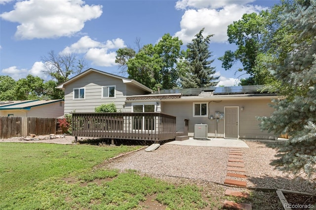 4589 S Sleepy Hollow Cir, Colorado Springs, CO 80917 - rear view of house with roof mounted solar panels, a wooden deck, and a patio