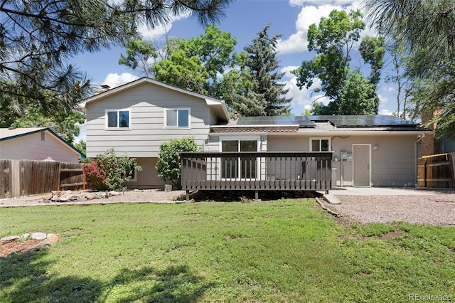 4589 S Sleepy Hollow Cir, Colorado Springs, CO 80917 - rear view of property with roof mounted solar panels and a wooden deck