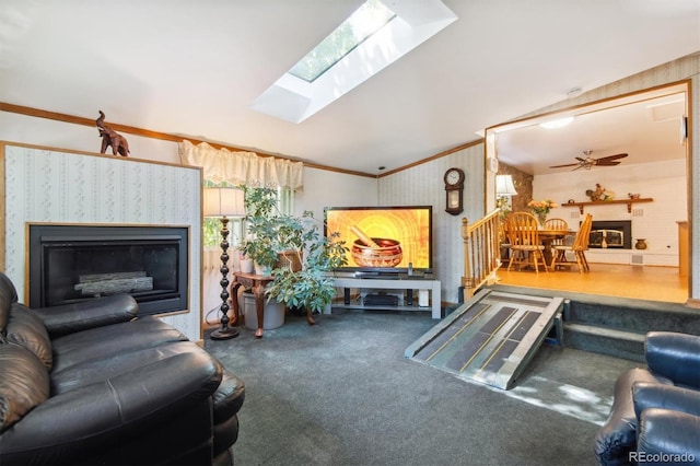 1922 Graves Ct, Northglenn, CO 80233 - carpeted living area with a glass covered fireplace, lofted ceiling, ornamental molding, a skylight, and ceiling fan