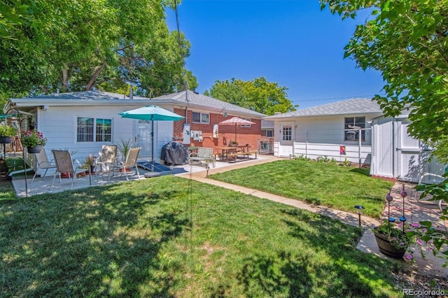 1922 Graves Ct, Northglenn, CO 80233 - rear view of house with a patio area and an outbuilding