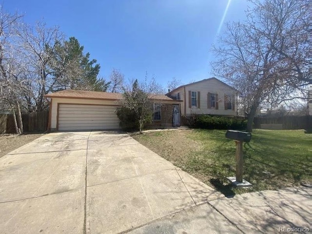 view of front of home with a garage and a front lawn