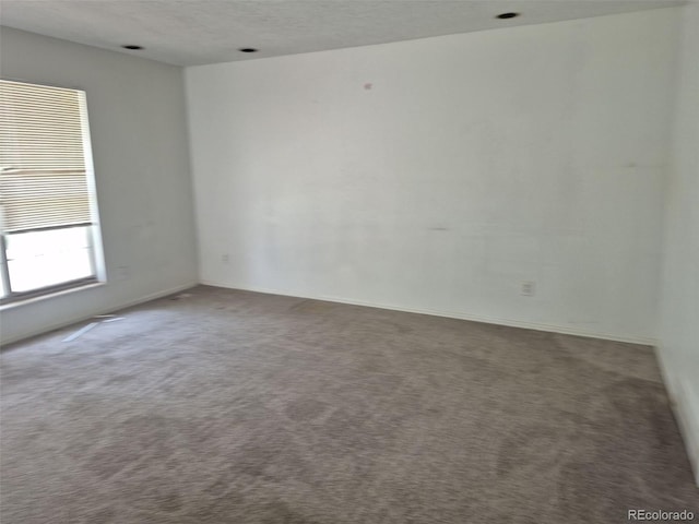 18249 E Mexico Pl, Aurora, CO 80017 - empty room with carpet floors, baseboards, and a textured ceiling