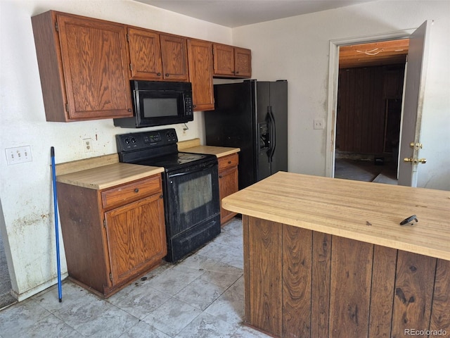 18249 E Mexico Pl, Aurora, CO 80017 - kitchen featuring black appliances, light countertops, and brown cabinets