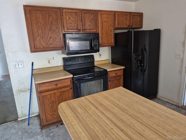 18249 E Mexico Pl, Aurora, CO 80017 - kitchen with black appliances, light countertops, and brown cabinets