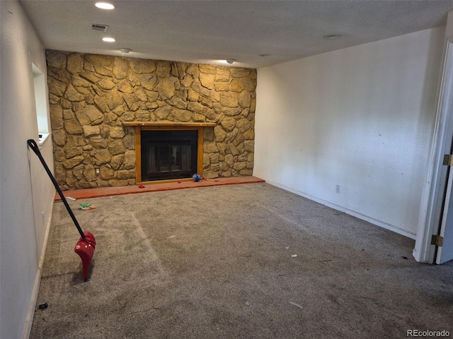 18249 E Mexico Pl, Aurora, CO 80017 - unfurnished living room featuring carpet flooring, a stone fireplace, baseboards, and a textured ceiling