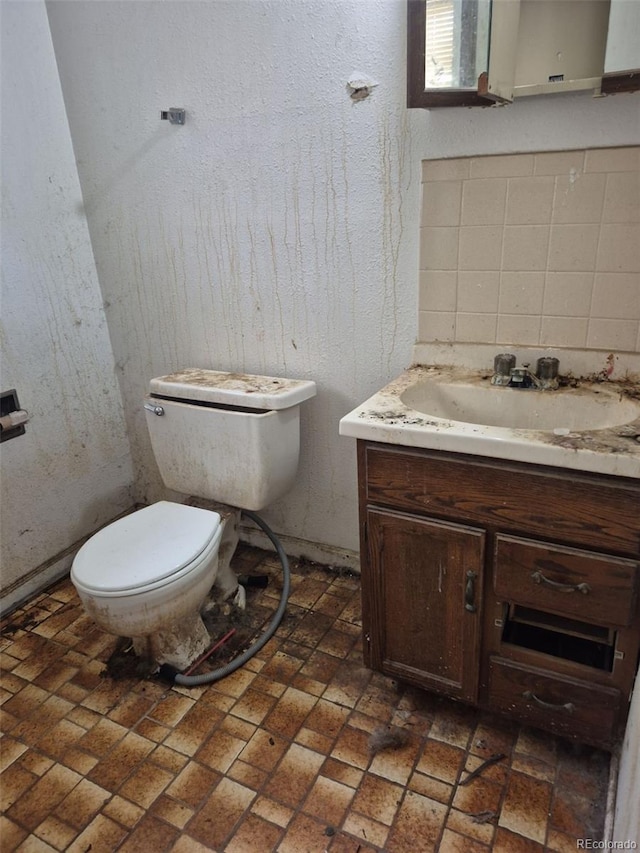 18249 E Mexico Pl, Aurora, CO 80017 - bathroom with vanity, toilet, and brick patterned flooring