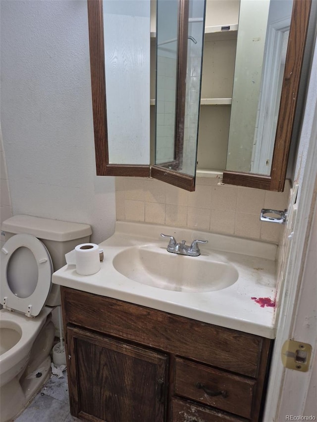18249 E Mexico Pl, Aurora, CO 80017 - bathroom featuring vanity, toilet, and decorative backsplash