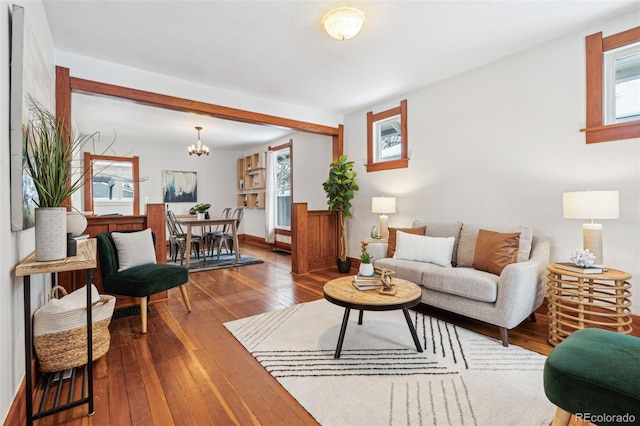 living room featuring hardwood / wood-style flooring, an inviting chandelier, and a wealth of natural light