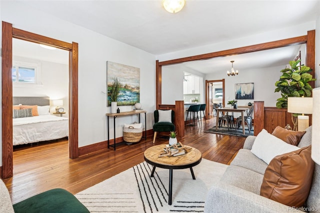 living room featuring hardwood / wood-style flooring and an inviting chandelier