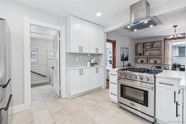 kitchen featuring island exhaust hood, backsplash, stainless steel range, white fridge, and white cabinetry