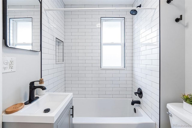 full bathroom featuring vanity, toilet, and tiled shower / bath