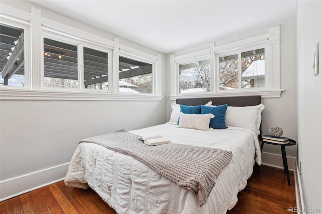 bedroom with dark hardwood / wood-style flooring