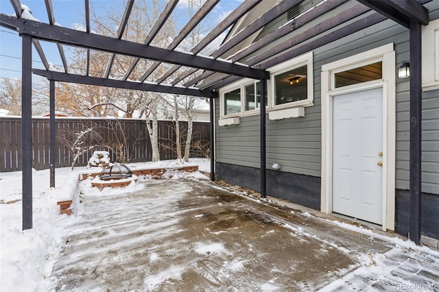 snow covered patio featuring a pergola