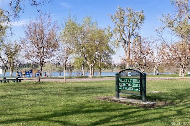 view of property's community with a yard and a water view