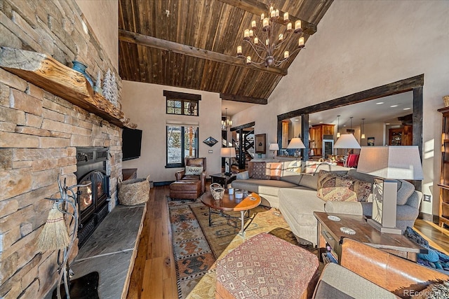 living room with a fireplace, beam ceiling, hardwood / wood-style flooring, high vaulted ceiling, and wooden ceiling