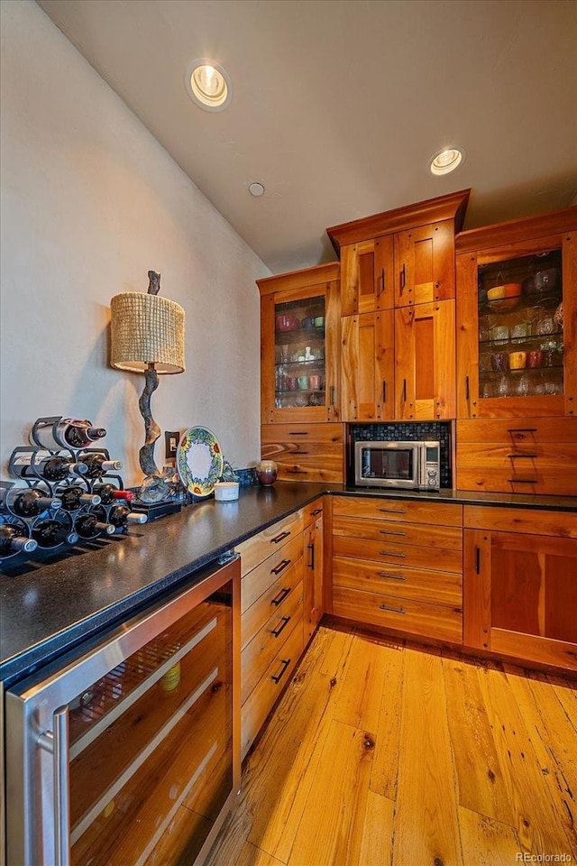 kitchen with light hardwood / wood-style floors and beverage cooler