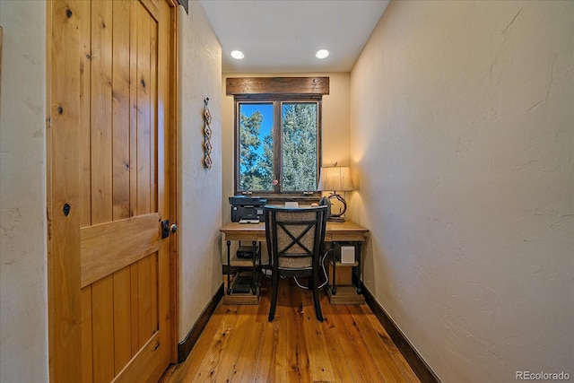 office with light wood-type flooring