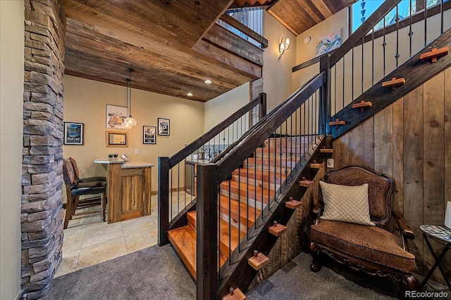 staircase featuring wood ceiling and tile patterned floors