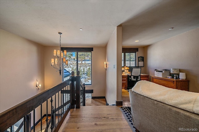 bedroom with a notable chandelier and light wood-type flooring