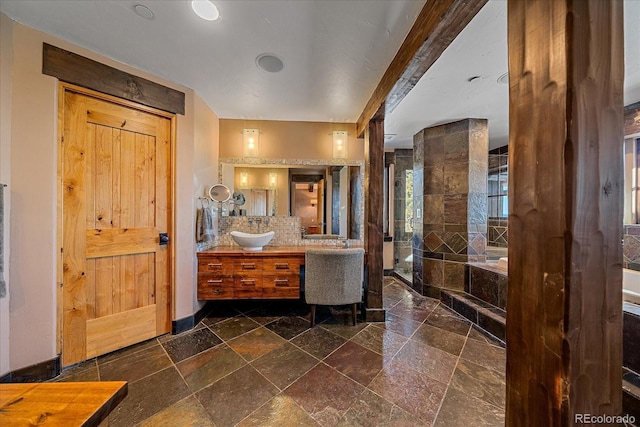 bathroom featuring decorative backsplash, separate shower and tub, and vanity