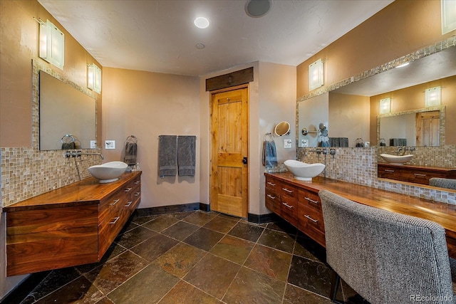 bathroom featuring backsplash and vanity