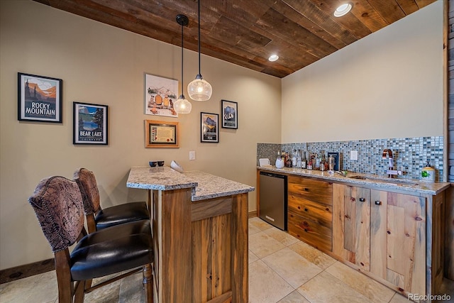 bar with pendant lighting, decorative backsplash, sink, dishwashing machine, and wooden ceiling