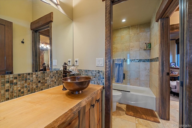 full bathroom featuring tasteful backsplash, toilet, vanity, tile patterned floors, and tiled shower / bath combo