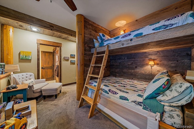 bedroom with ceiling fan, carpet flooring, and beamed ceiling