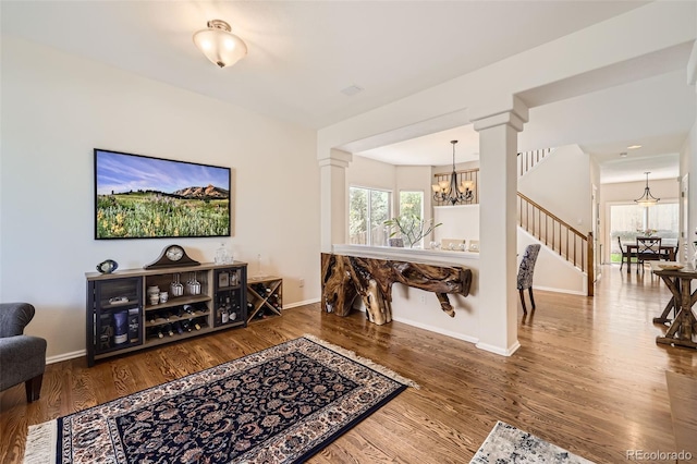 3744 Gypsum Ct, Superior, CO 80027 - living area with an inviting chandelier, baseboards, stairs, and wood finished floors