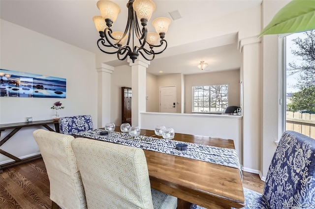 3744 Gypsum Ct, Superior, CO 80027 - dining area featuring decorative columns, baseboards, a notable chandelier, and wood finished floors