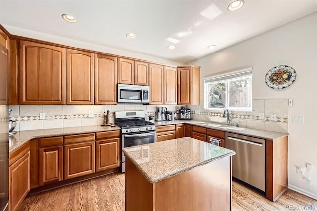 3744 Gypsum Ct, Superior, CO 80027 - kitchen with light stone countertops, a sink, stainless steel appliances, decorative backsplash, and light wood-type flooring