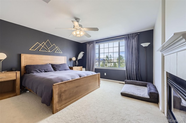 3744 Gypsum Ct, Superior, CO 80027 - bedroom featuring a ceiling fan, carpet flooring, baseboards, and a glass covered fireplace
